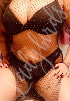 Person in black rhinestone lingerie and matching fishnet bodysuit.