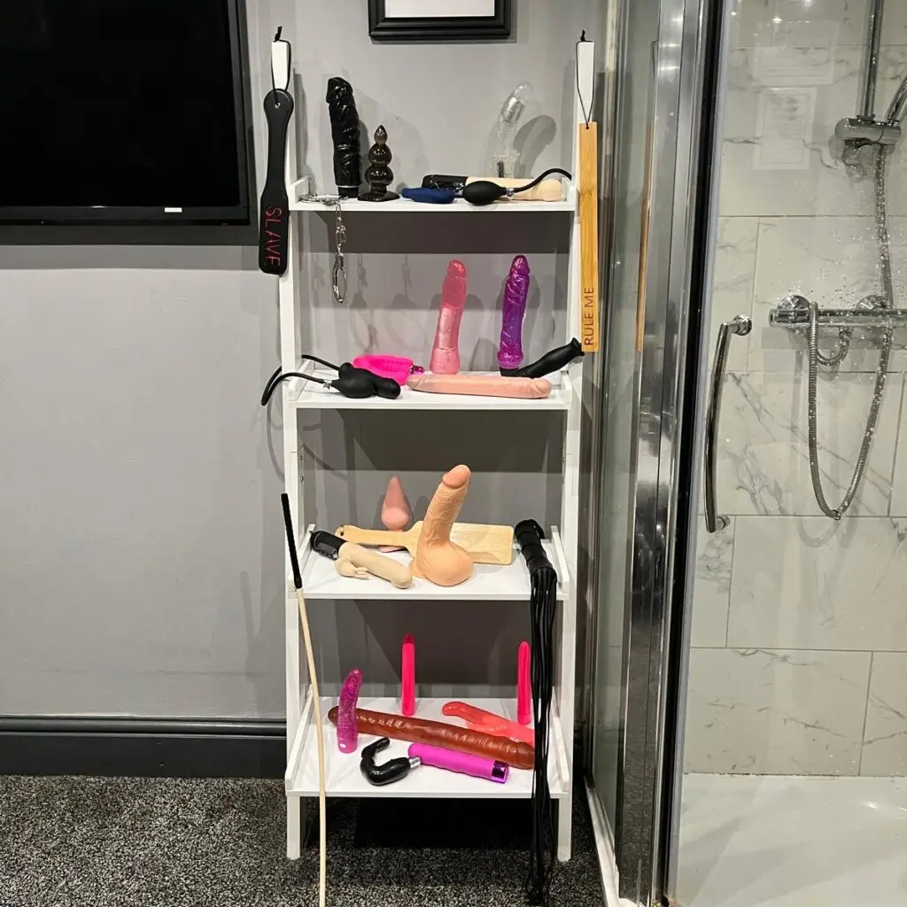 Selection of adult toys beside the en-suite shower at Ladybirds Manchester